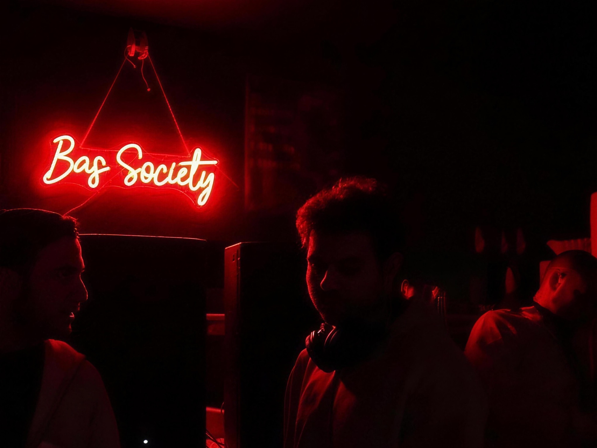 The BAS Society neon sign at a community gathering